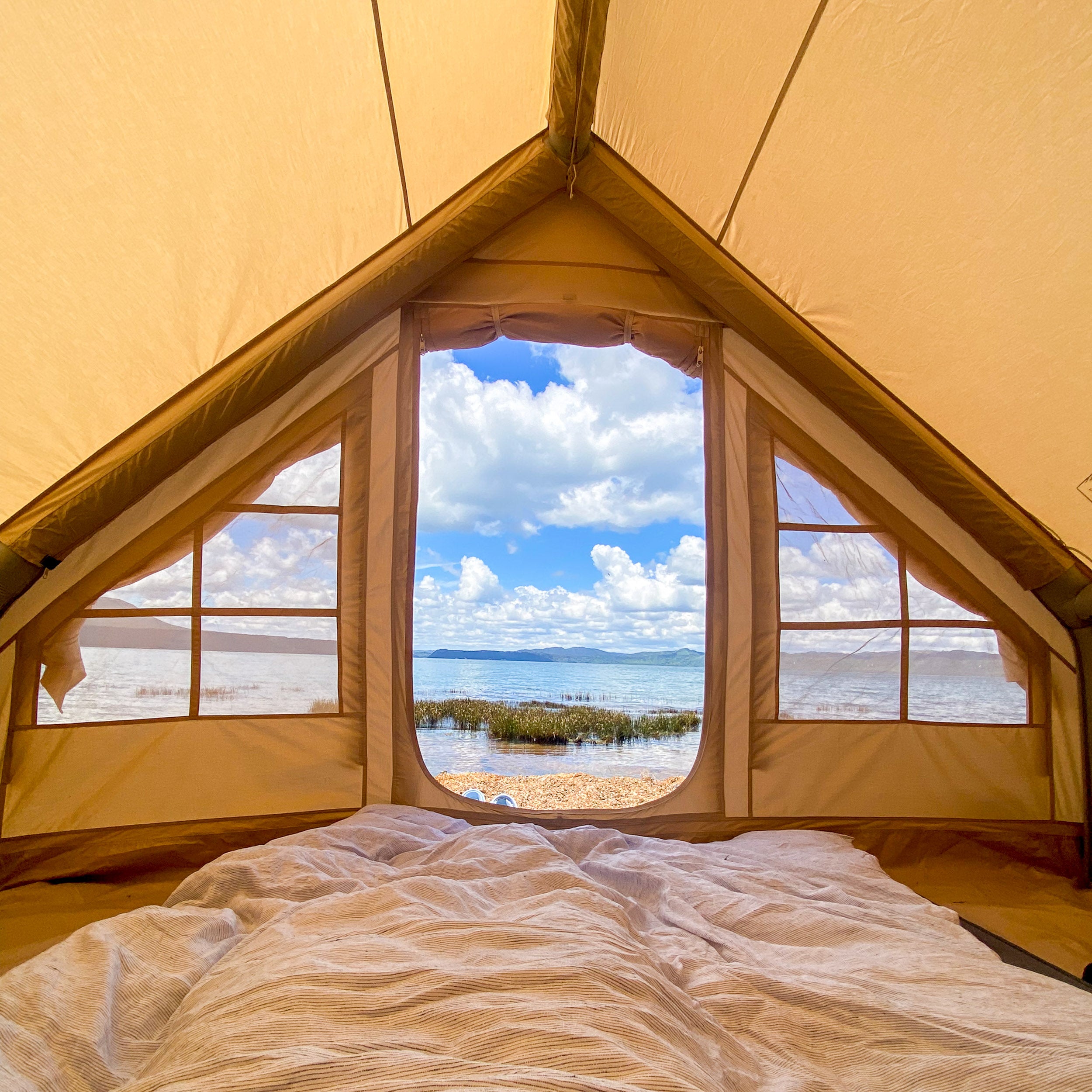 Inflatable tent looking out at lake arawera on the beach front